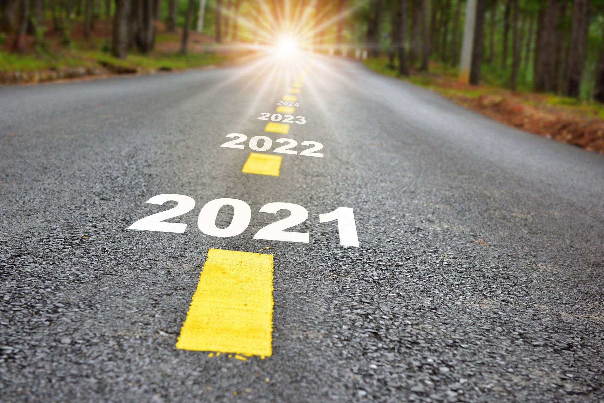 New year journey 2021 to 2024 on asphalt road surface with marking lines and sunlight
